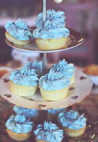 Close-up of blue cupcakes on cakestand