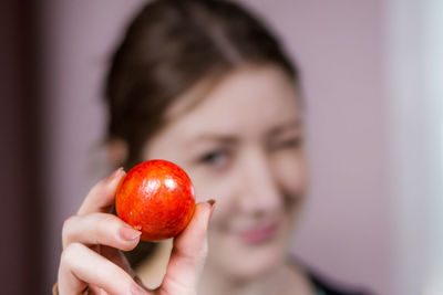 Close-up of woman holding strawberry