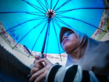 Portrait of young man holding camera