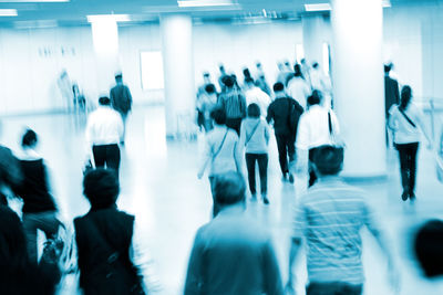 Defocused image of people walking in city