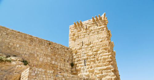 Low angle view of historical building against blue sky