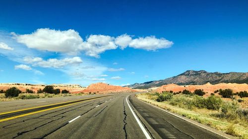 Empty road along countryside landscape