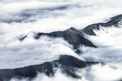 Scenic view of mountains against cloudy sky