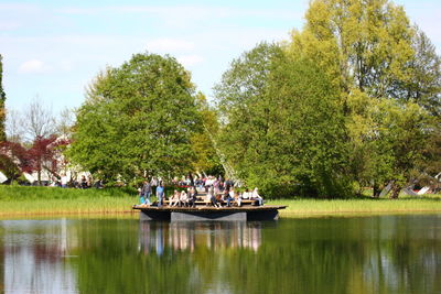 People sitting in park against sky
