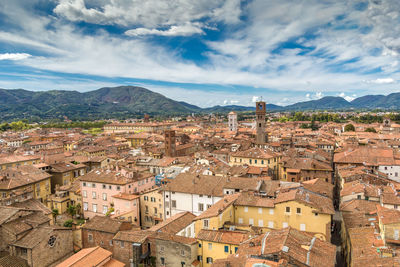 Aerial view of town against cloudy sky