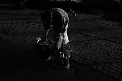 Rear view of woman standing on footpath