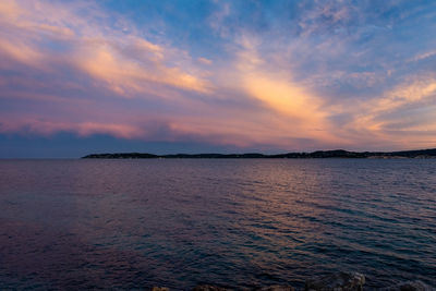 Scenic view of sea against romantic sky at sunset