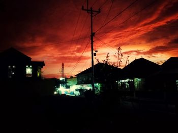 Silhouette buildings against sky at night