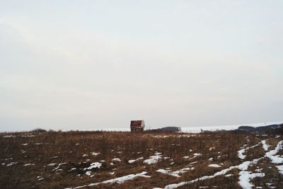 Scenic view of field against sky during winter