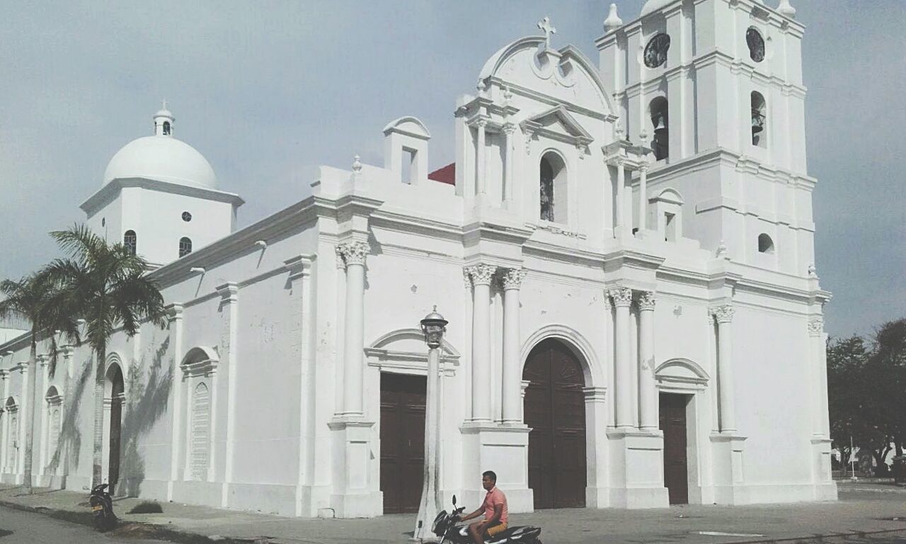 VIEW OF CHURCH WITH PEOPLE IN BACKGROUND