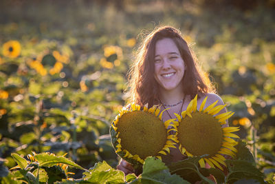 Portrait of smiling woman in sunflower farm