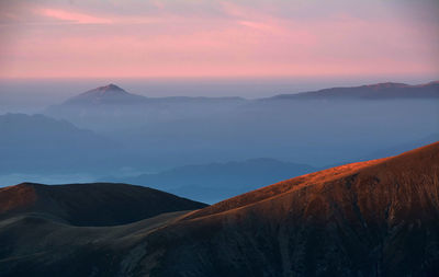 Scenic view of mountains against sky during sunset