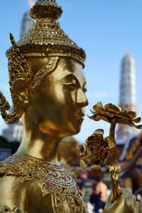 Close-up of gold statue at wat phra kaeo
