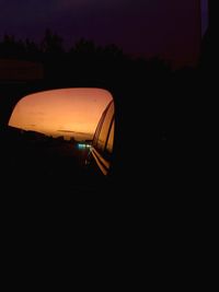 Silhouette car against illuminated sky at night