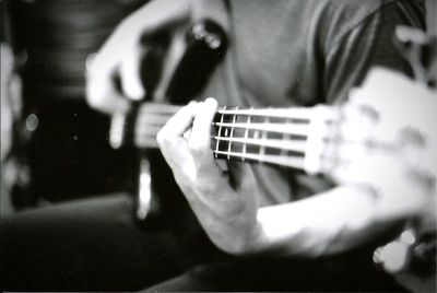 Cropped image of man playing guitar