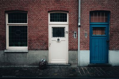 Cat looking through window of building
