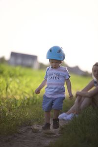 Portrait of boy standing on field