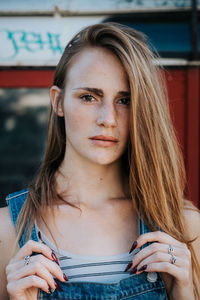 Portrait of young woman against bus