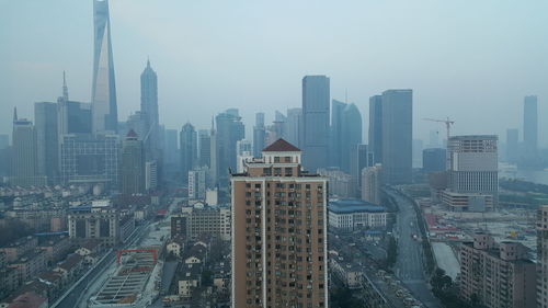 Aerial view of modern buildings in city against sky