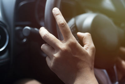 Close-up of human hand in car