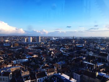 High angle view of cityscape against blue sky