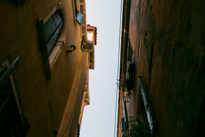 Narrow street amidst buildings against sky