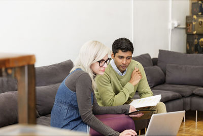 Business people using laptop during meeting in creative office