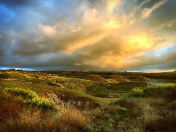 Scenic view of landscape against cloudy sky