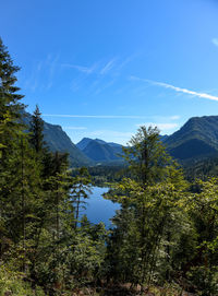 Scenic view of mountains against blue sky