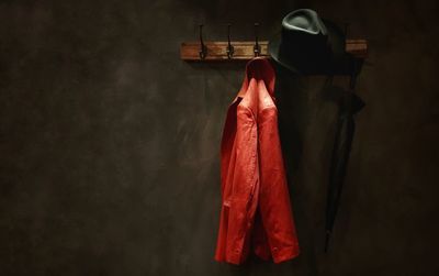 Close-up of jacket hanging on hook against wall