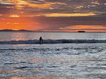 Scenic view of sea against sky during sunset, surfing, huntington beach, waves, sunset