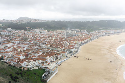 Top view of the streets with white houses and orange tiled roofs, an ancient portuguese city