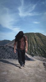 Rear view of man standing on mountain