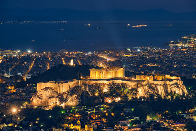 High angle view of illuminated buildings in city at night