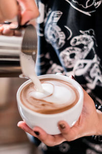 Close-up of hand holding coffee cup