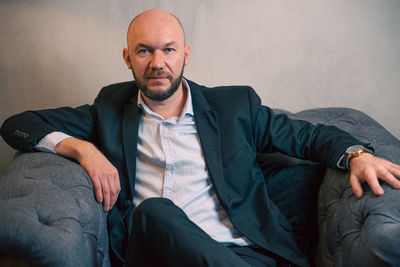 Portrait of businessman sitting on sofa