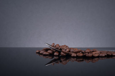 Close-up of hand holding food over white background
