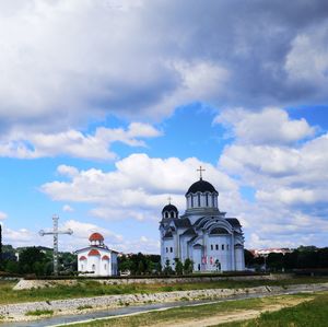 Church by building against sky