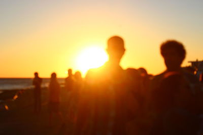 Silhouette people against clear sky during sunset