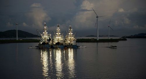 Commercial dock by sea against sky