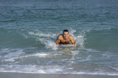 Young man swimming in sea