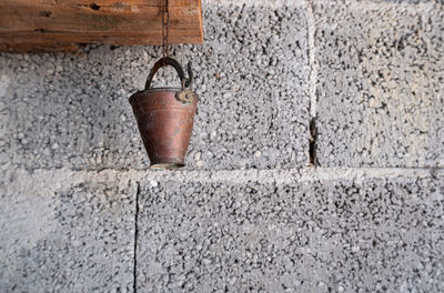 Close-up of old rusty hanging on wall