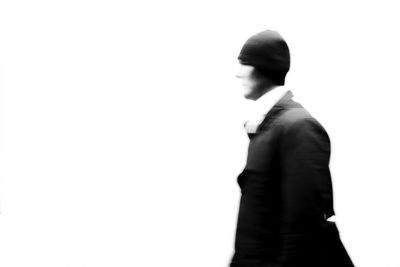 Side view of young man against white background