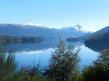 Scenic view of lake and mountains against clear sky