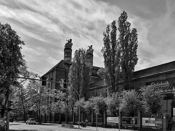 Low angle view of trees and buildings against sky