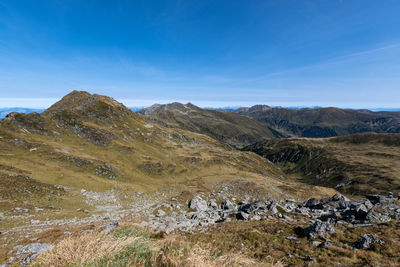Scenic view of mountains against blue sky