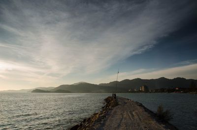 Scenic view of sea against cloudy sky