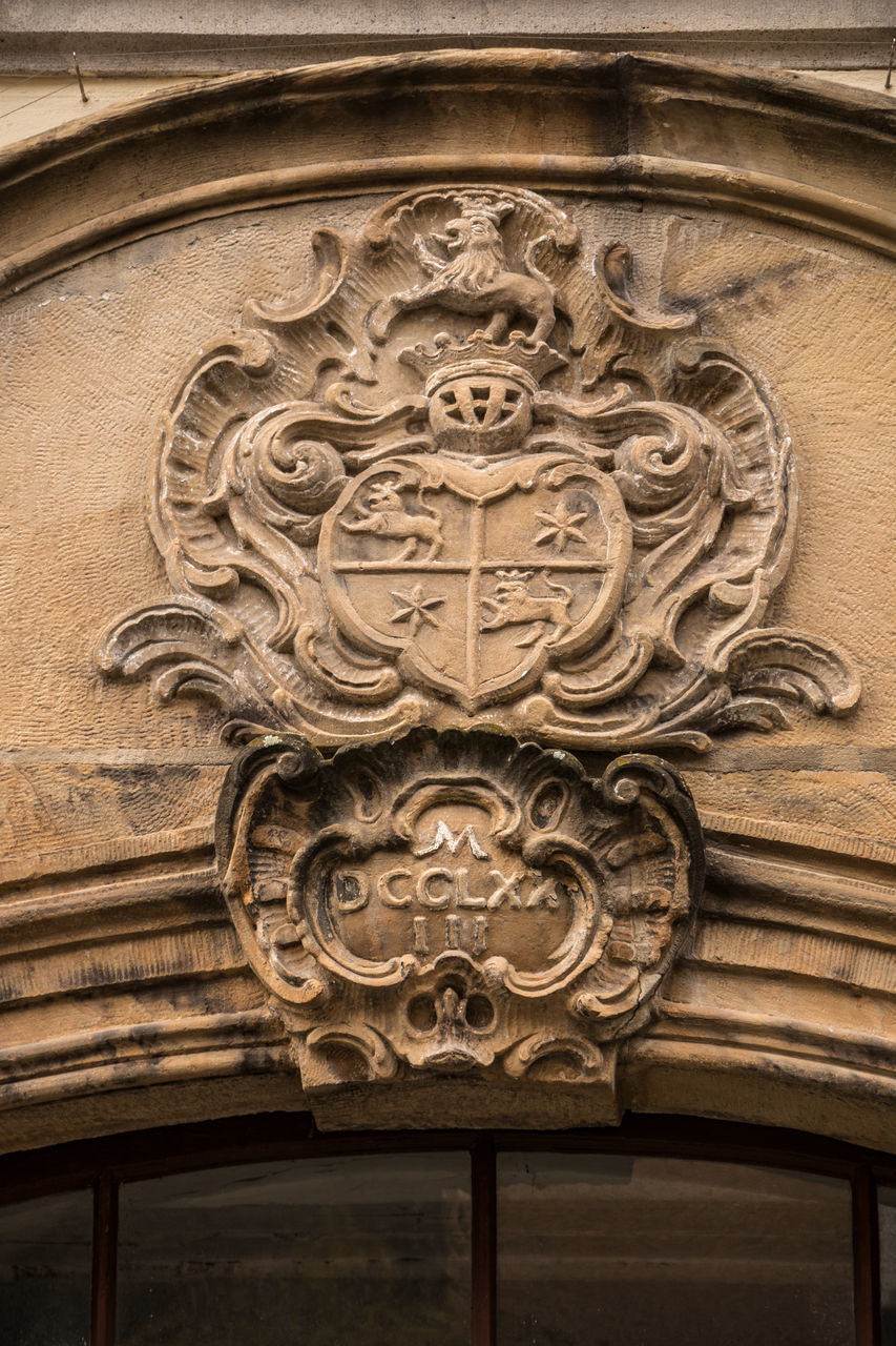 LOW ANGLE VIEW OF CARVINGS ON WALL