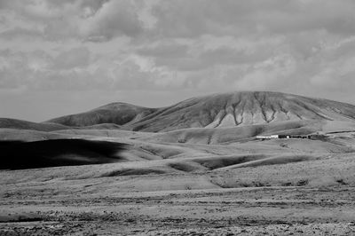 Scenic view of mountains against cloudy sky