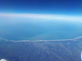 Scenic view of sea against blue sky
